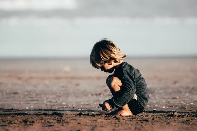 Barn som leker på stranden. Foto: Fermin Rodrigez Penelas, Unsplash.